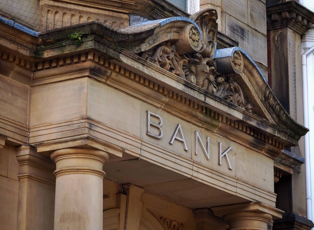 concrete bank building with detailed architectural elements